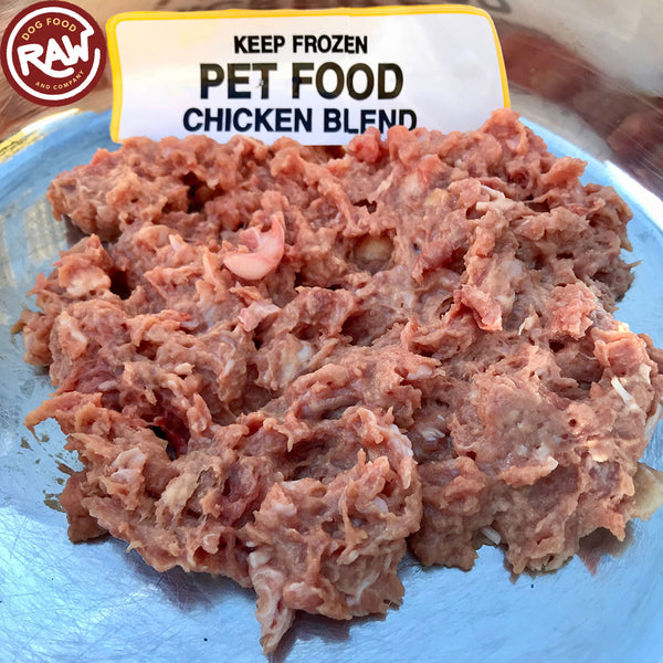 Preparing fresh raw meat for barf dog food with a mix of poultry