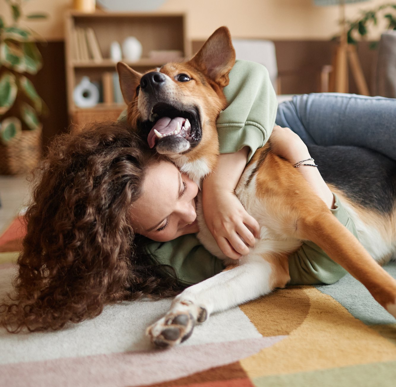 A customer lying on the floor hugging her dog